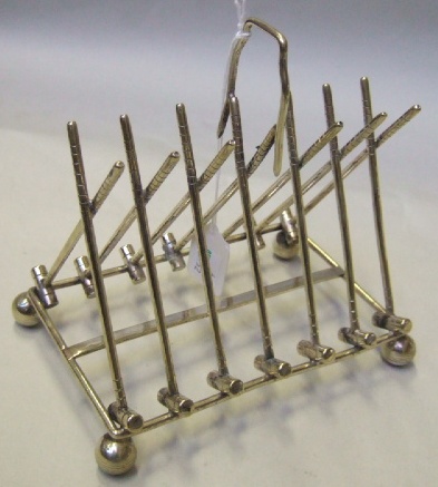 Appraisal: A plated novelty six division toastrack designed as a row