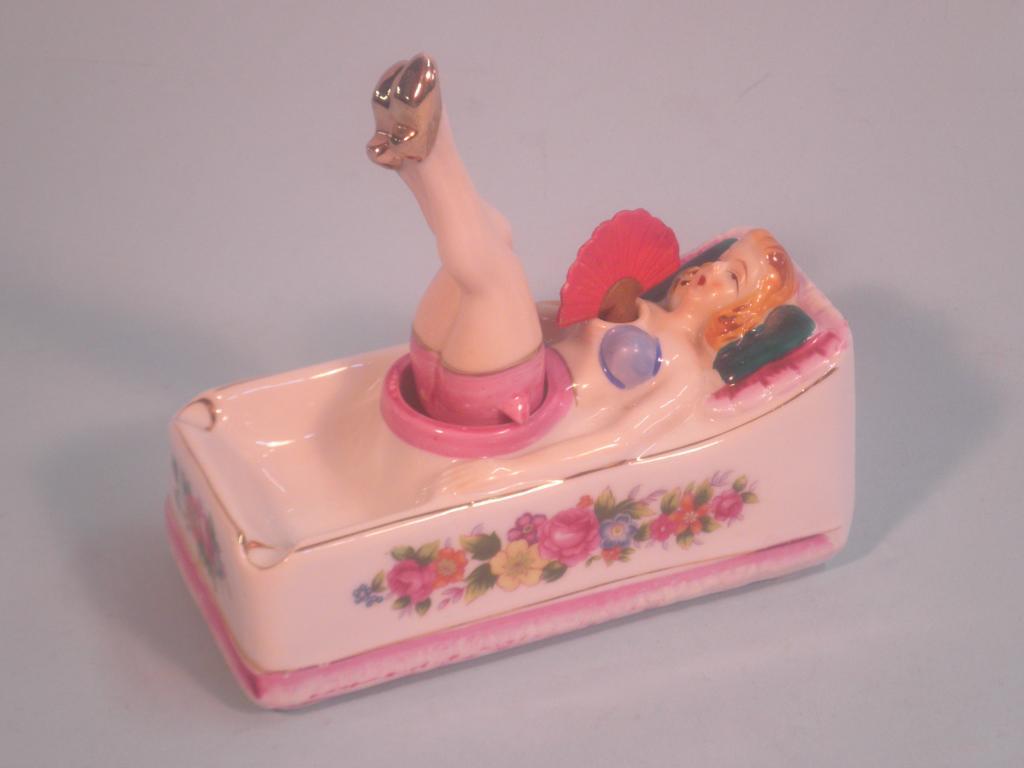 Appraisal: A continental porcelain and novelty ashtray in the form of