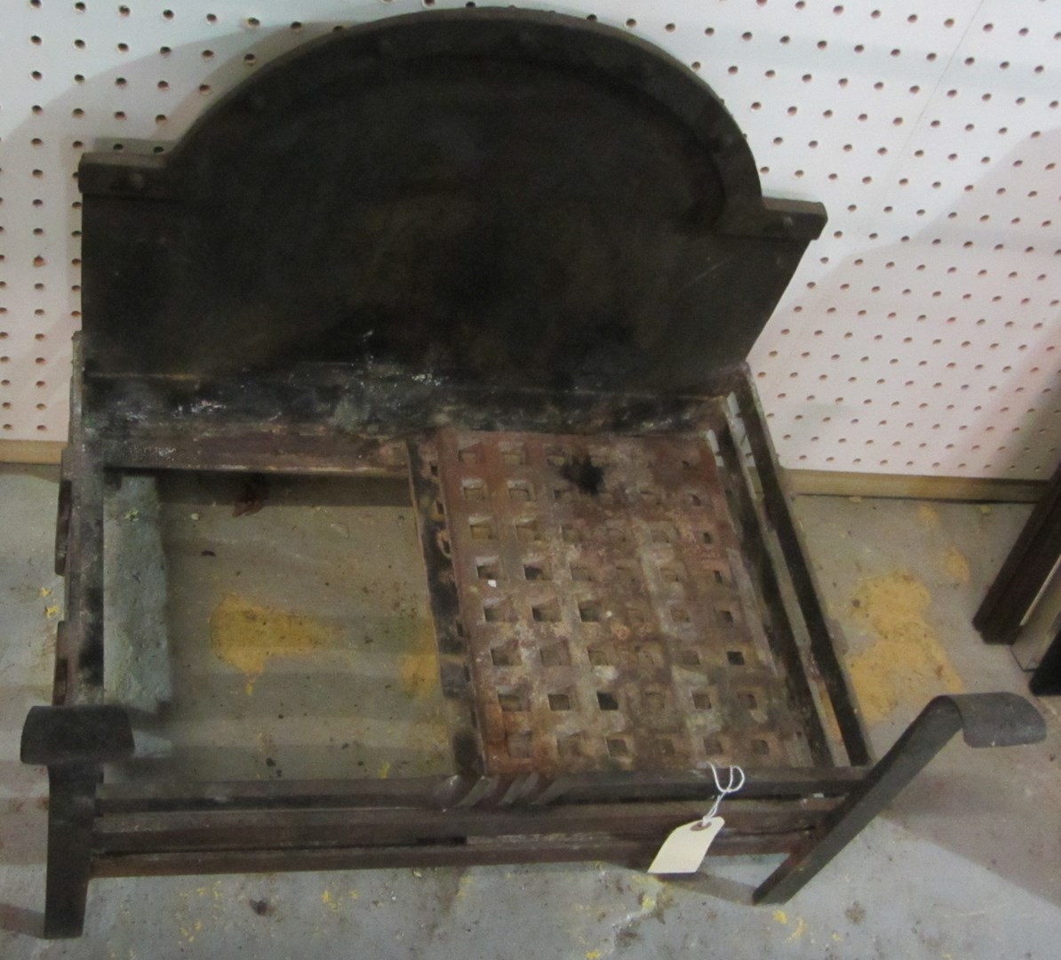 Appraisal: A cast iron fire basket with integral back