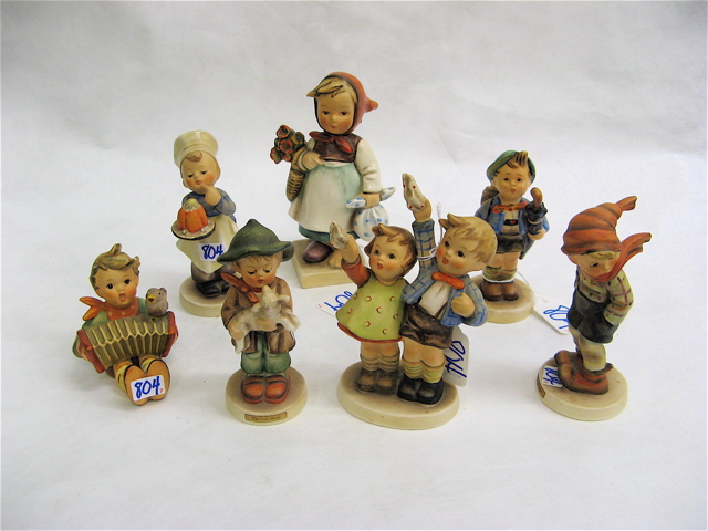 Appraisal: SEVEN GERMAN HUMMEL FIGURES Weary Wanderer HUM TM- - H