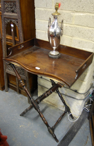 Appraisal: An early th century mahogany serpentine-front butler's tray with three-quarter