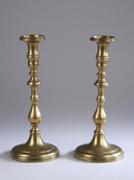 Appraisal: PAIR CONTINENTAL BRASS CANDLESTICKS th century Baluster form shaft atop