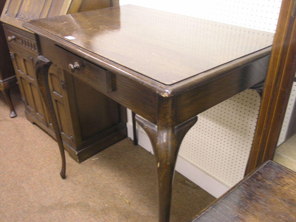 Appraisal: A solid dark oak serving table with single frieze drawer