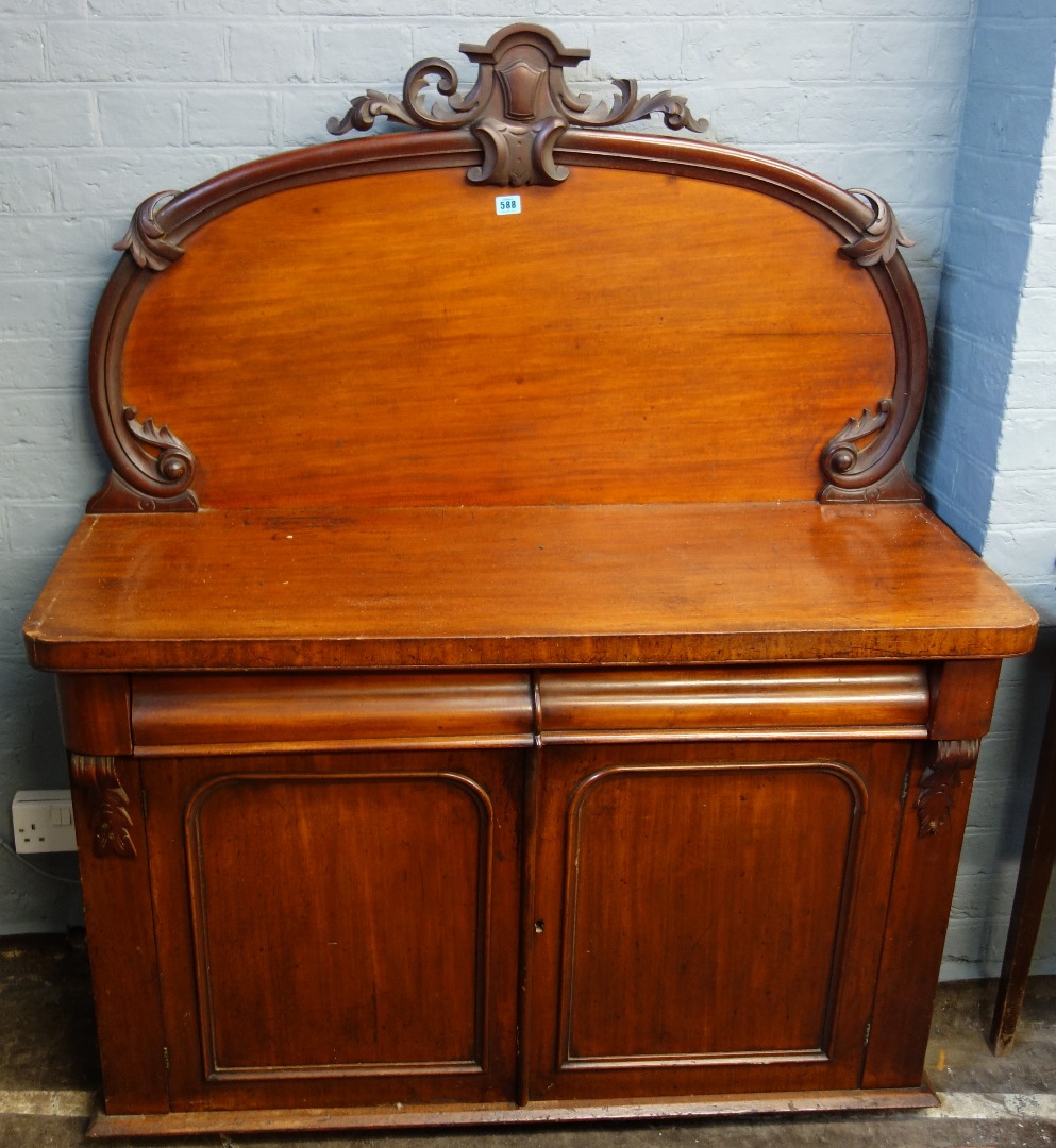 Appraisal: A Victorian mahogany chiffonier with arched carved back two drawers