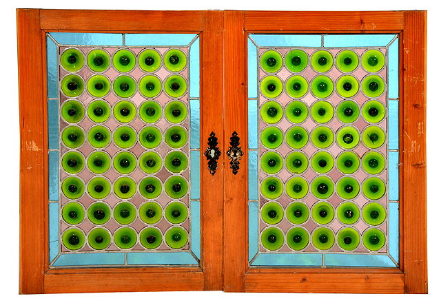 Appraisal: A PAIR OF STAINED GLASS PANELS decorated with green roundels