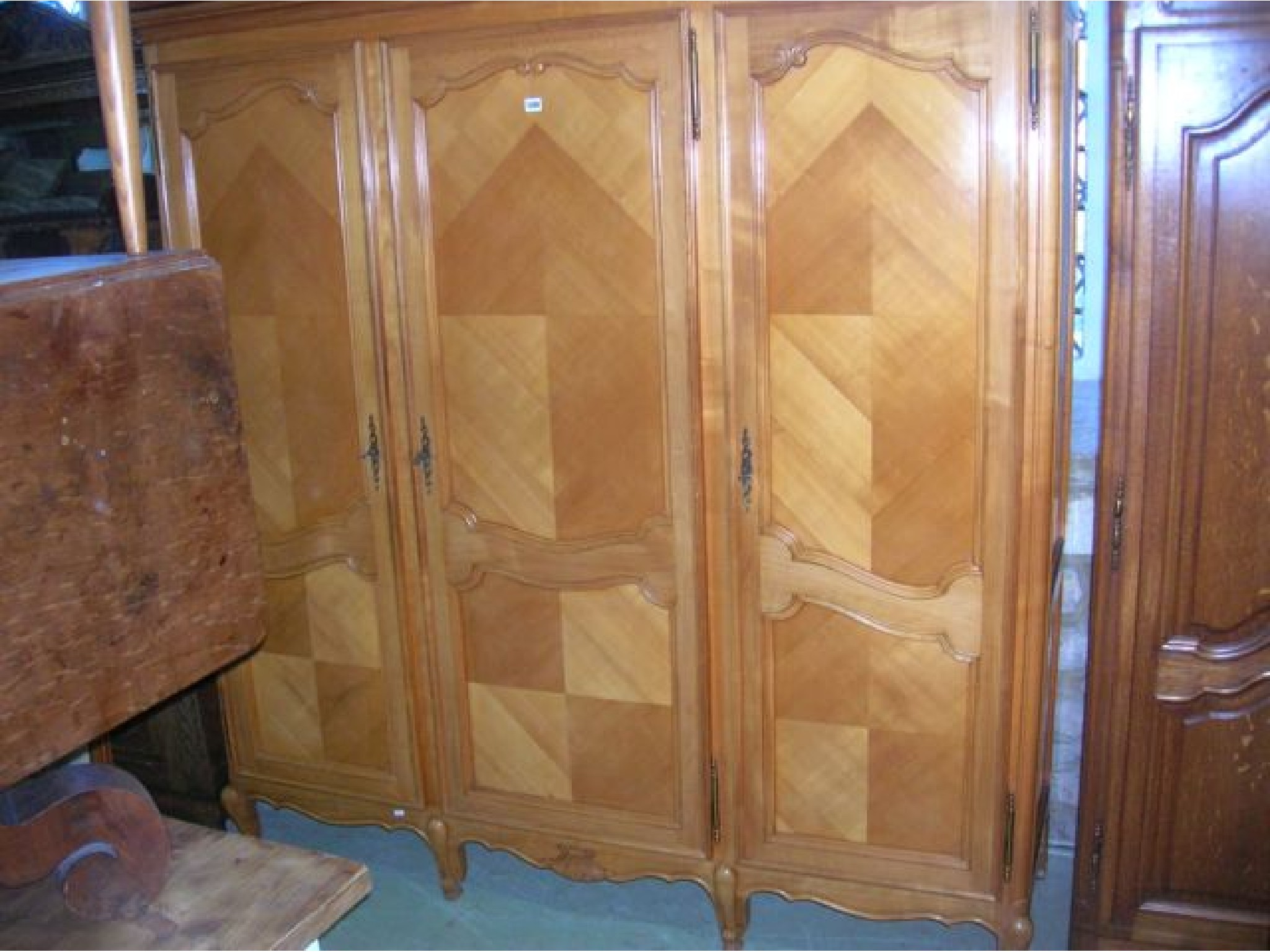 Appraisal: A continental knockdown satin walnut triple wardrobe with moulded cornice