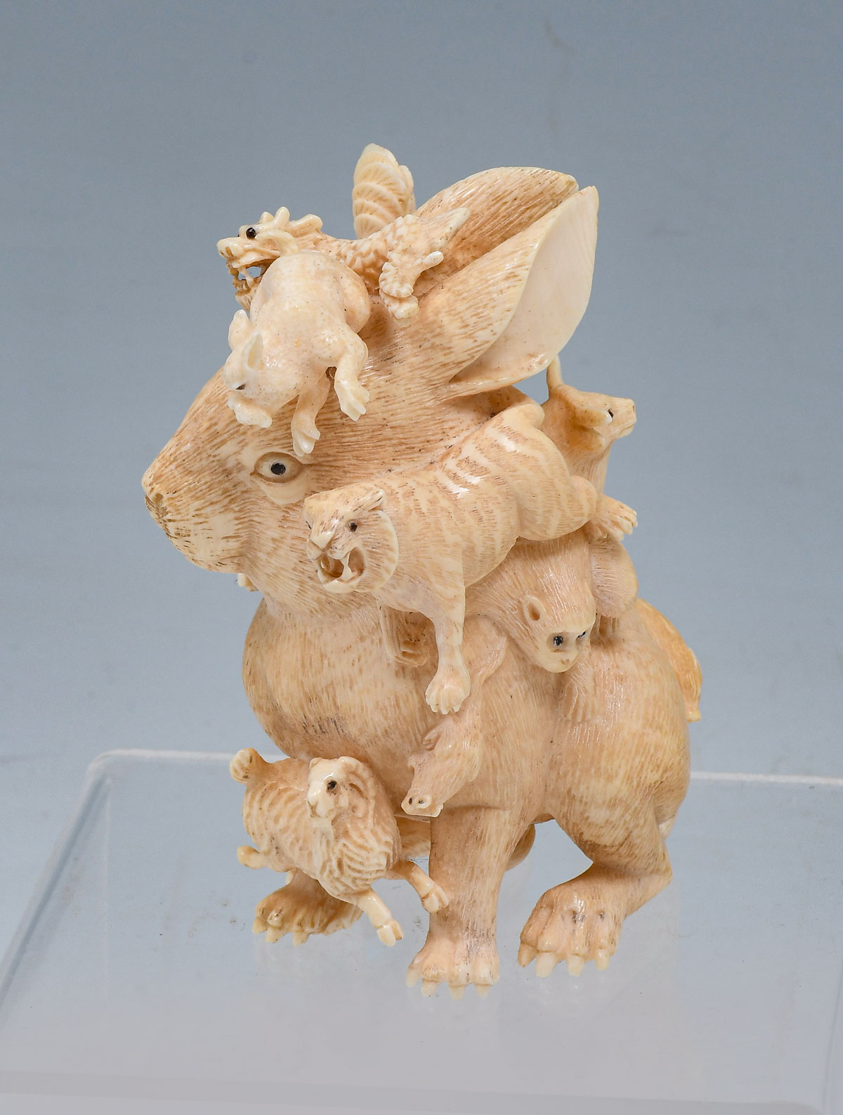 Appraisal: LARGE CARVED JAPANESE IVORY RABBIT WITH ZODIAC ANIMALS High relief