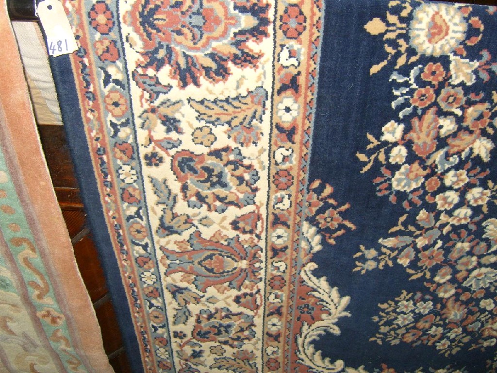 Appraisal: A Persian style carpet floral medallions upon a blue field