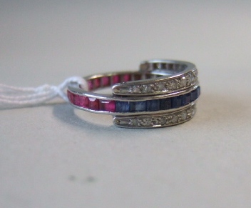 Appraisal: A ruby sapphire and diamond set foldover eternity ring mounted