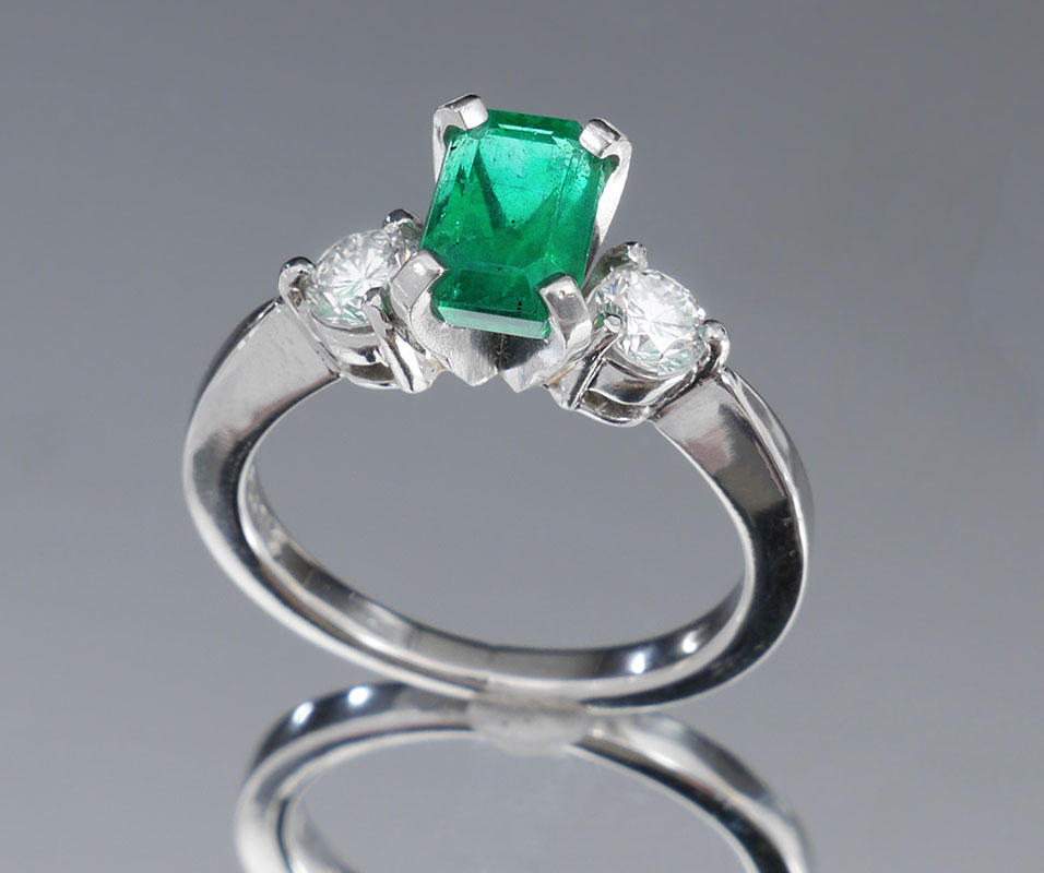 Appraisal: PLATINUM EMERALD ENGAGEMENT RING WITH DIAMONDS Ct emerald is VS