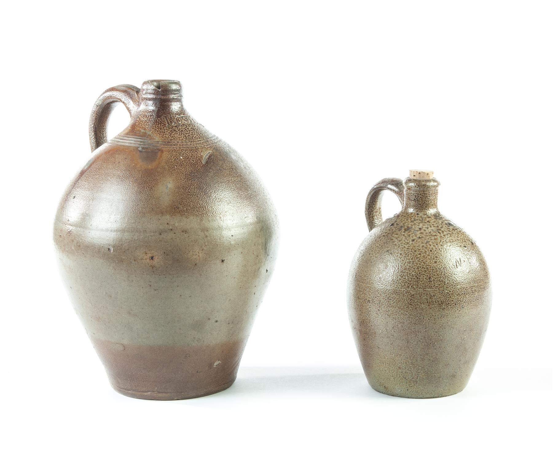 Appraisal: TWO STONEWARE JUGS American st quarter- th century Applied handles