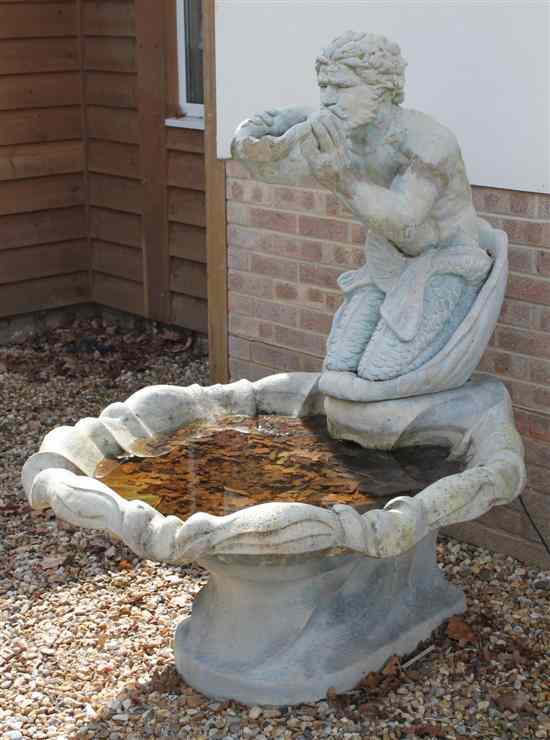 Appraisal: A composition garden fountain modelled as a merman blowing a