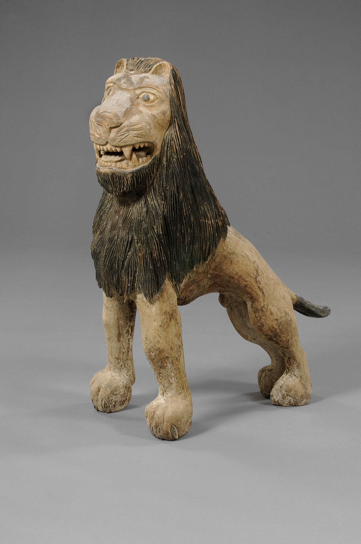 Appraisal: AMERICAN FOLK ART CARVED AND PAINTED SMILING LION In seated