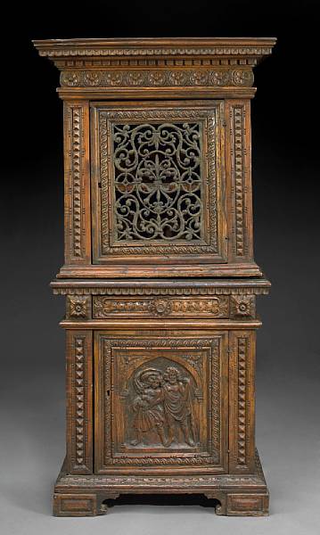 Appraisal: An Italian Baroque style carved walnut cabinet incorporating antique and