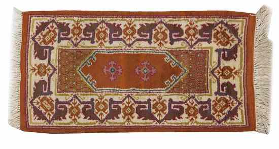 Appraisal: A Tunisian Wool Mat having a central cartouche on a