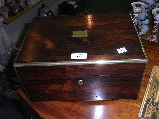 Appraisal: A VICTORIAN ROSEWOOD VANITY CASE the interior part fitted with