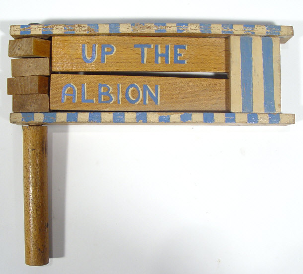 Appraisal: Wooden football rattle painted in Brighton and Hove Albion colours