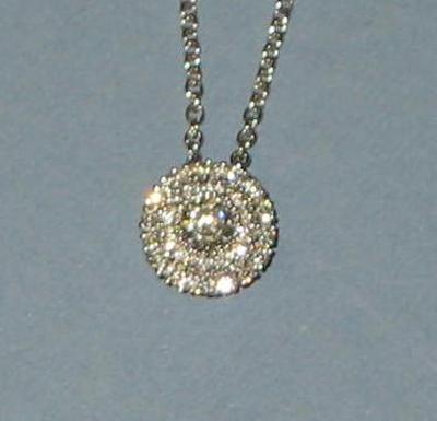 Appraisal: A DIAMOND PENDANT modelled as a circular cluster with larger