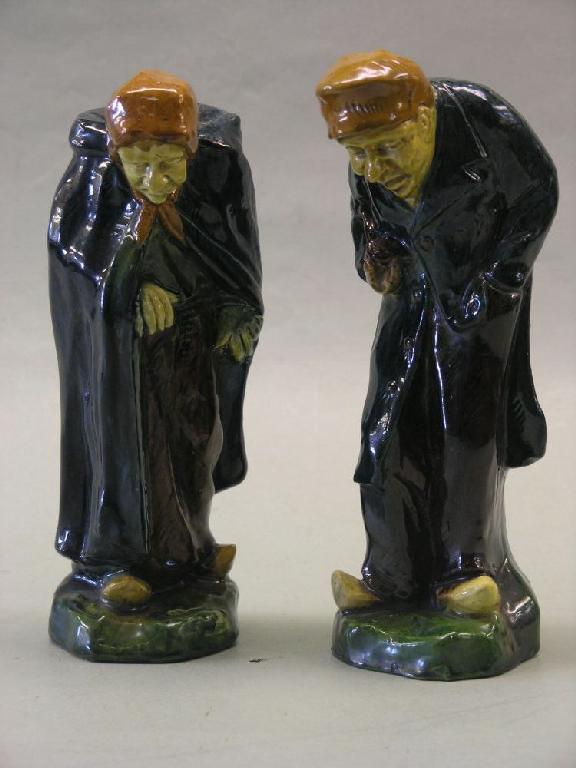 Appraisal: A pair of Dutch earthenware figures elderly gent and female