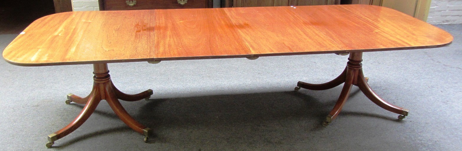 Appraisal: A George III style mahogany twin pedestal dining table to