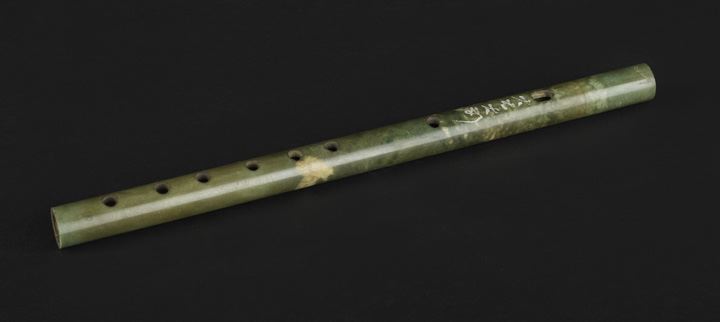 Appraisal: Chinese Carved Nephrite Jade Flute the mottled green and beige