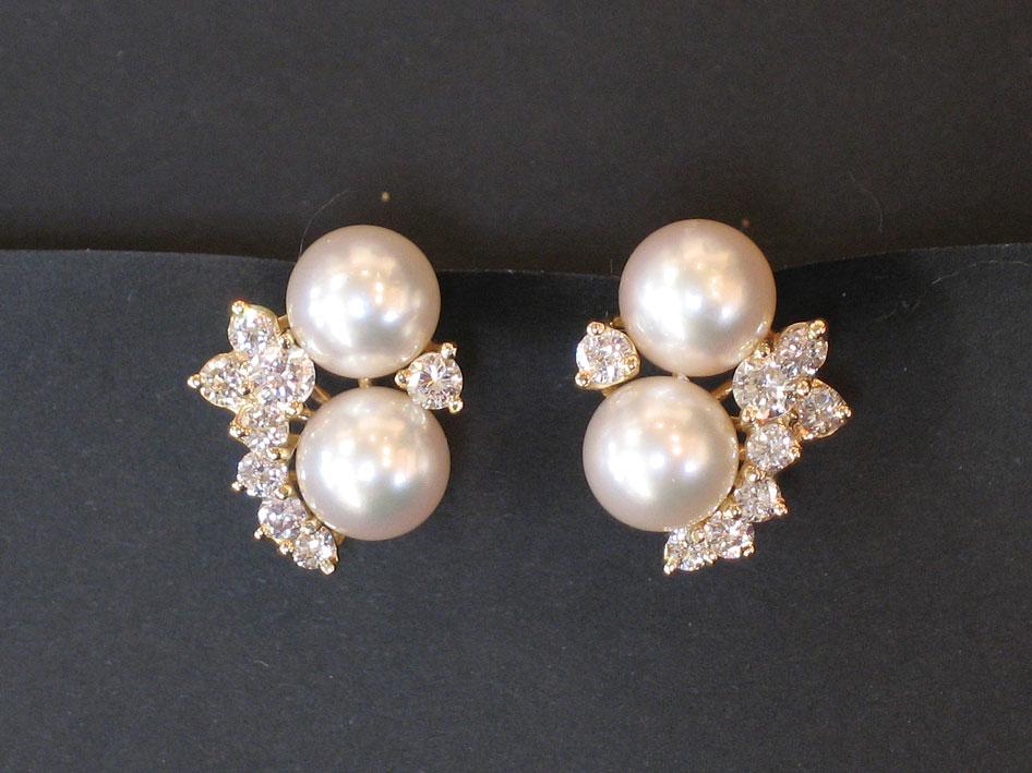 Appraisal: A PAIR OF DIAMOND AND PEARL EAR STUDS the two