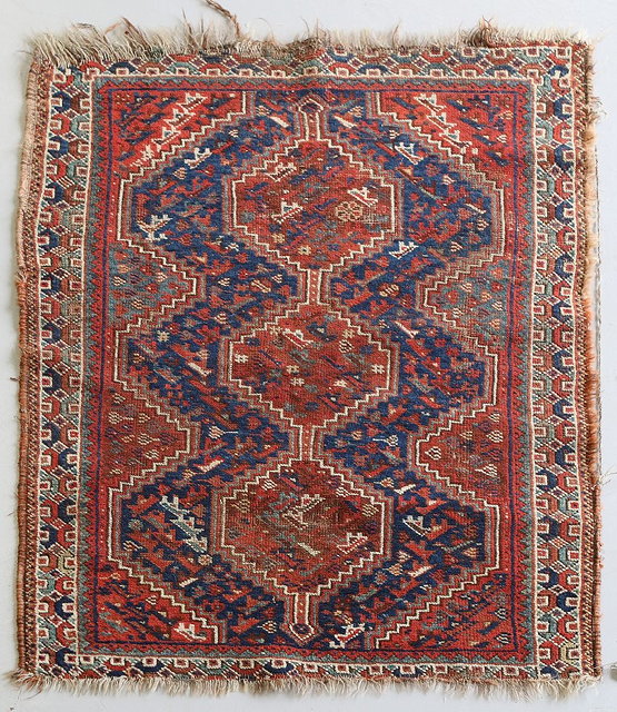 Appraisal: A SHIRAZ MAT with inter-connecting rust ground medallion and geometric