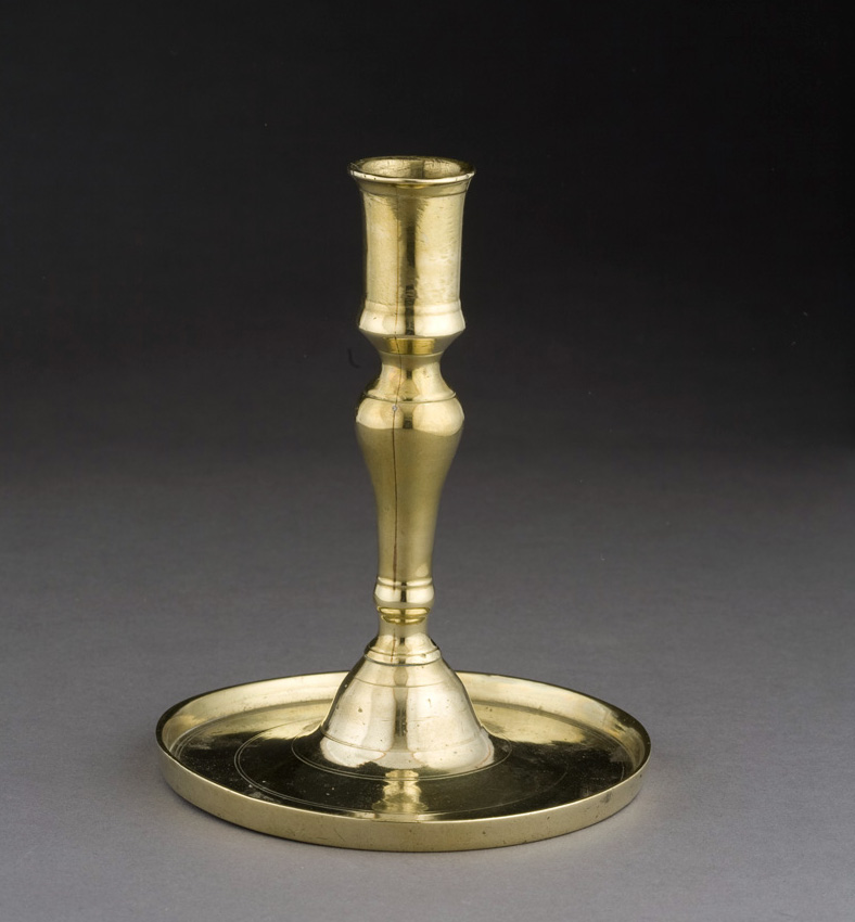 Appraisal: CONTINENTAL BRASS CANDLESTICK EIGHTEENTH CENTURY The cylindrical nozzle above the