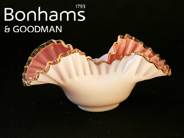 Appraisal: A Victorian sweetmeat basket with folded frilled lip on cranberry