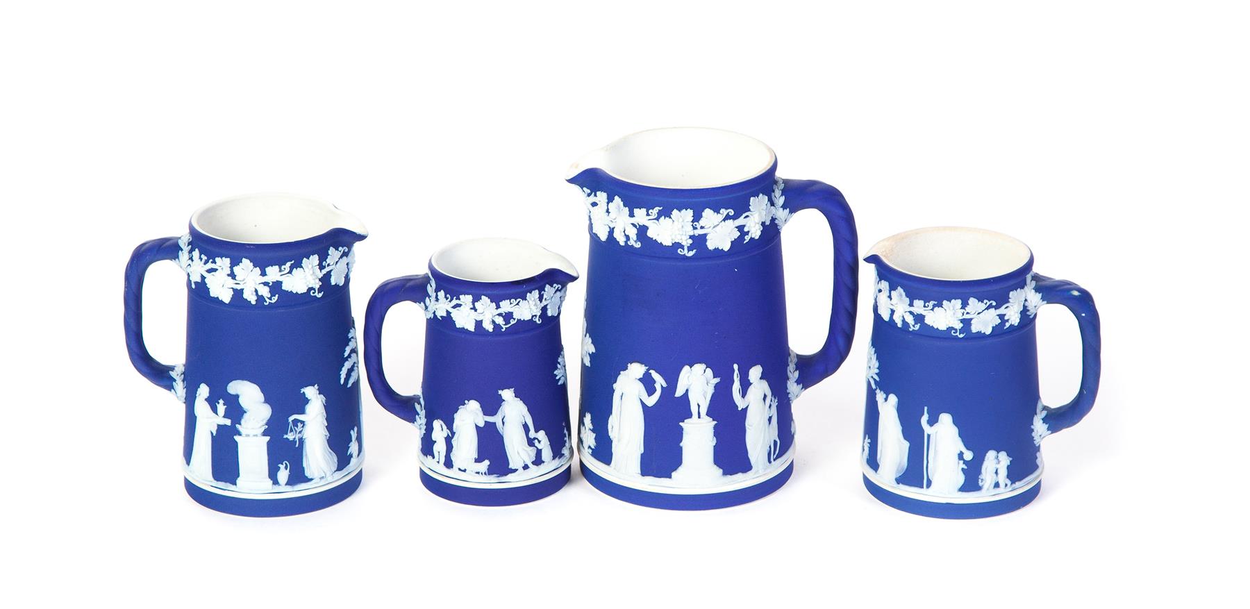 Appraisal: FOUR GRADUATED WEDGWOOD DARK BLUE DIP JASPERWARE CREAMERS England th