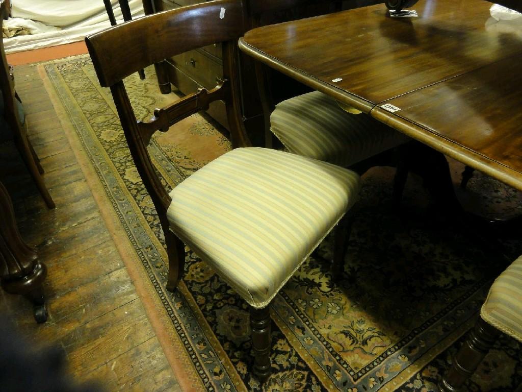 Appraisal: A Georgian mahogany twin pillar dining table raised on ring