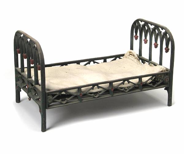 Appraisal: A Victorian style cast iron doll bed height in width