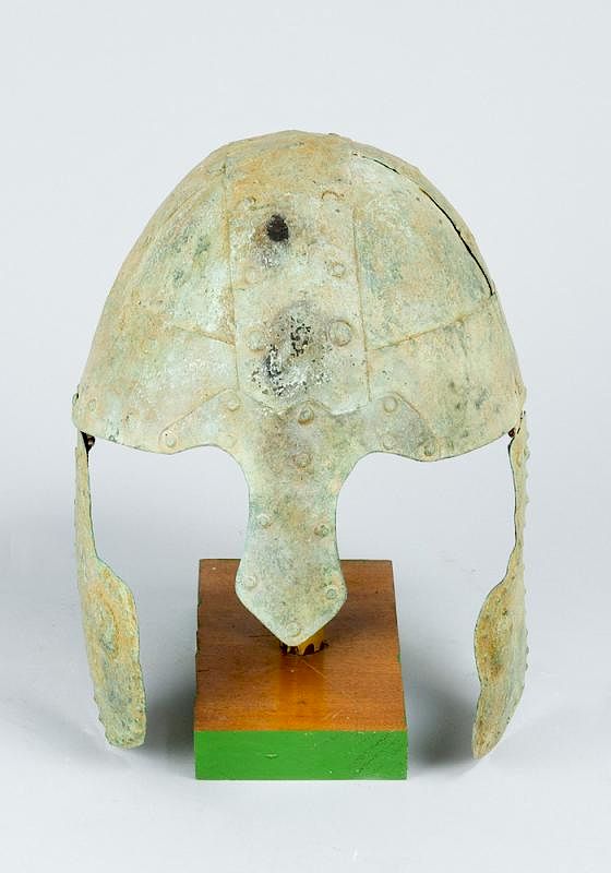 Appraisal: Archaic bronze helmet Archaic bronze helmet with arched top nose