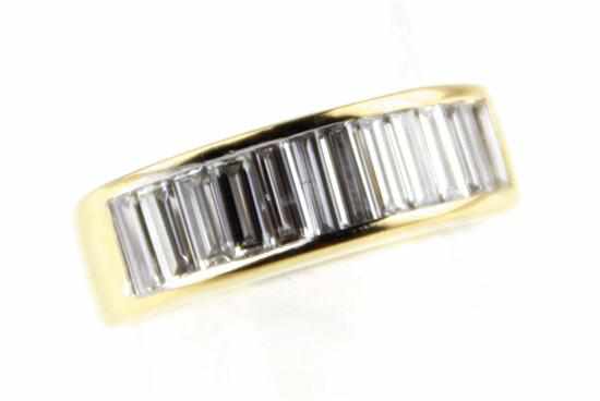 Appraisal: Diamond and gold band K yellow gold channel-set with baguette