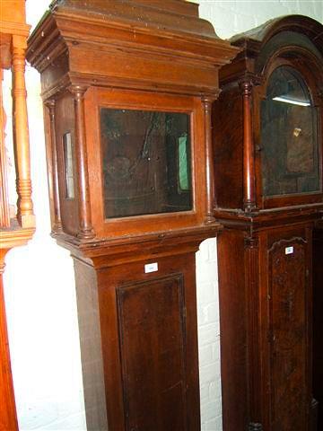 Appraisal: An oak long case clock case with caddy top hood