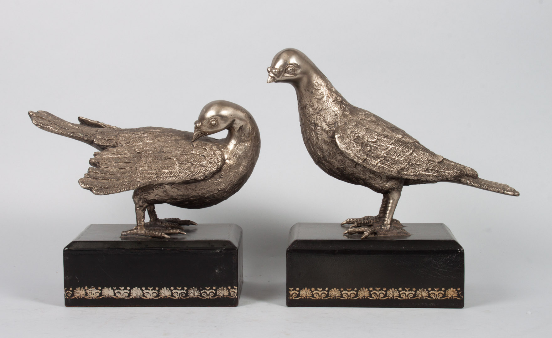 Appraisal: Pair of silvered metal dove figures each modeled as dove