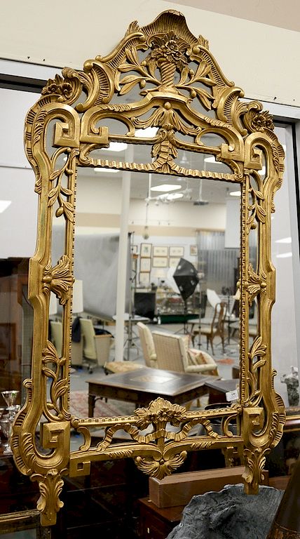 Appraisal: Continental Rococo style giltwood mirror foliate frame and surmounted by