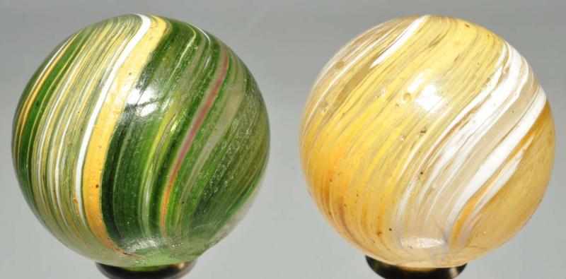 Appraisal: Lot of Banded Transparent Marbles Description Pair of banded transparent