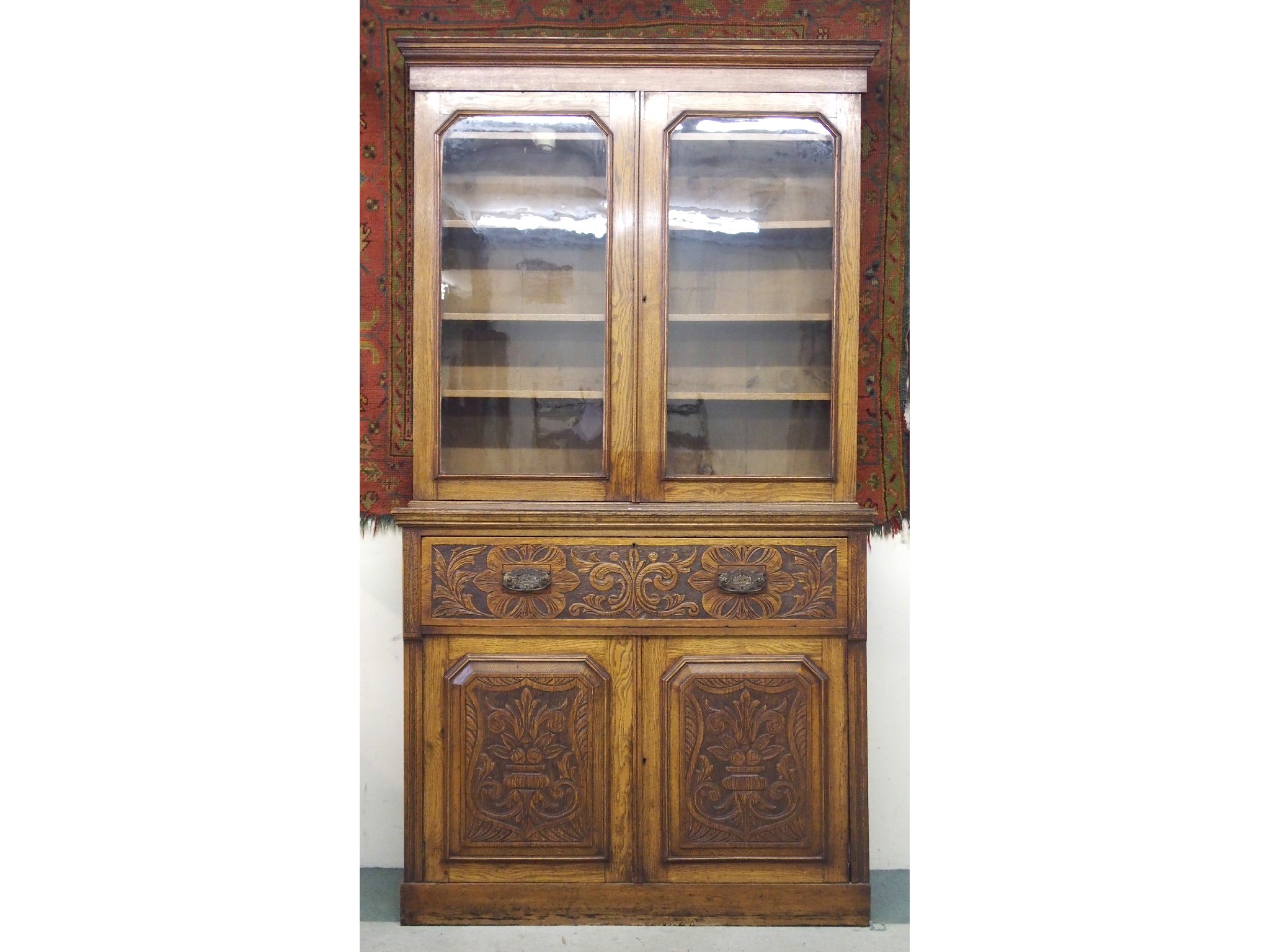 Appraisal: A Victorian oak secretaire bookcasewith a pair of glazed doors