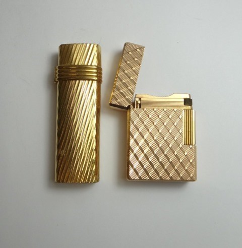 Appraisal: A gilt metal cased Christian Dior Paris gas lighter decorated