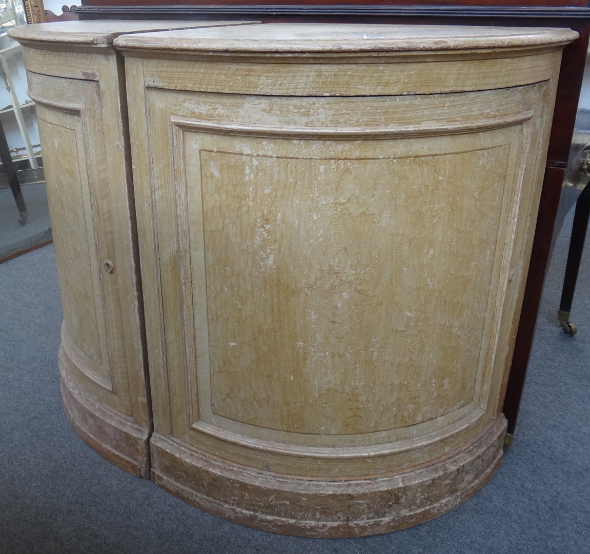 Appraisal: A pair of painted pine single door bowfront corner cupboards