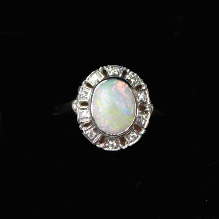 Appraisal: LADY'S OPAL AND DIAMOND RING the central oval opal cabochon