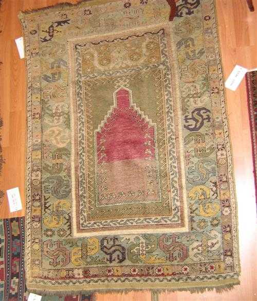 Appraisal: MUDJUR antique Pink and beige mihrab with light green spandrels