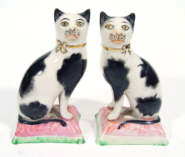 Appraisal: Pair of hand painted Staffordshire black and white cats on