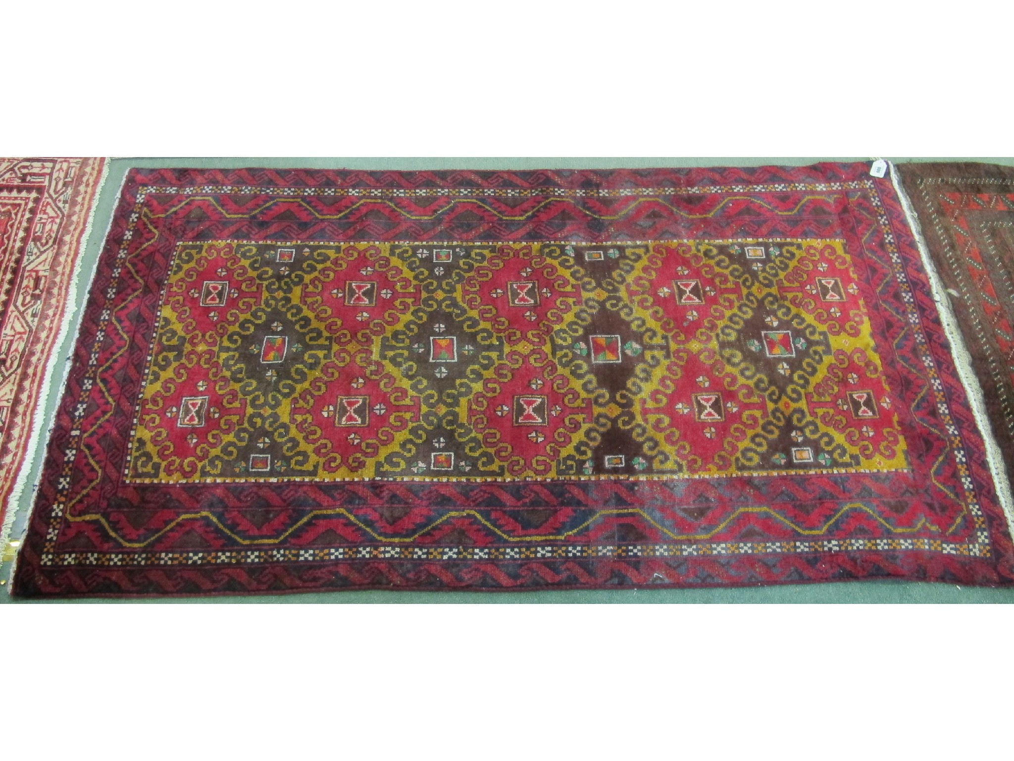 Appraisal: A Baluchi rug on a gold and red ground x