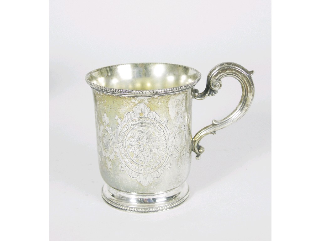 Appraisal: A Victorian Christening Mug with floral engraved cartouches scroll handle