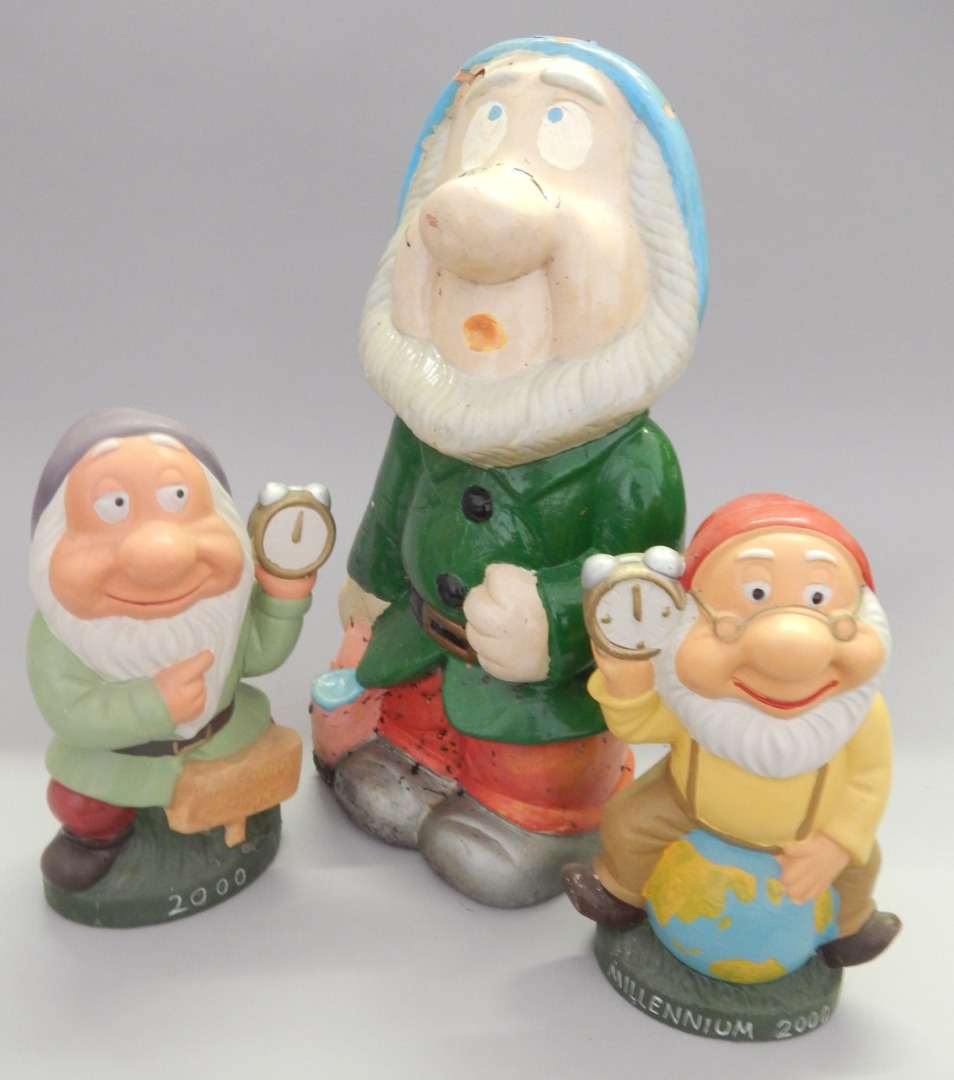 Appraisal: Three Millennium garden gnomes or dwarfs each holding a clock