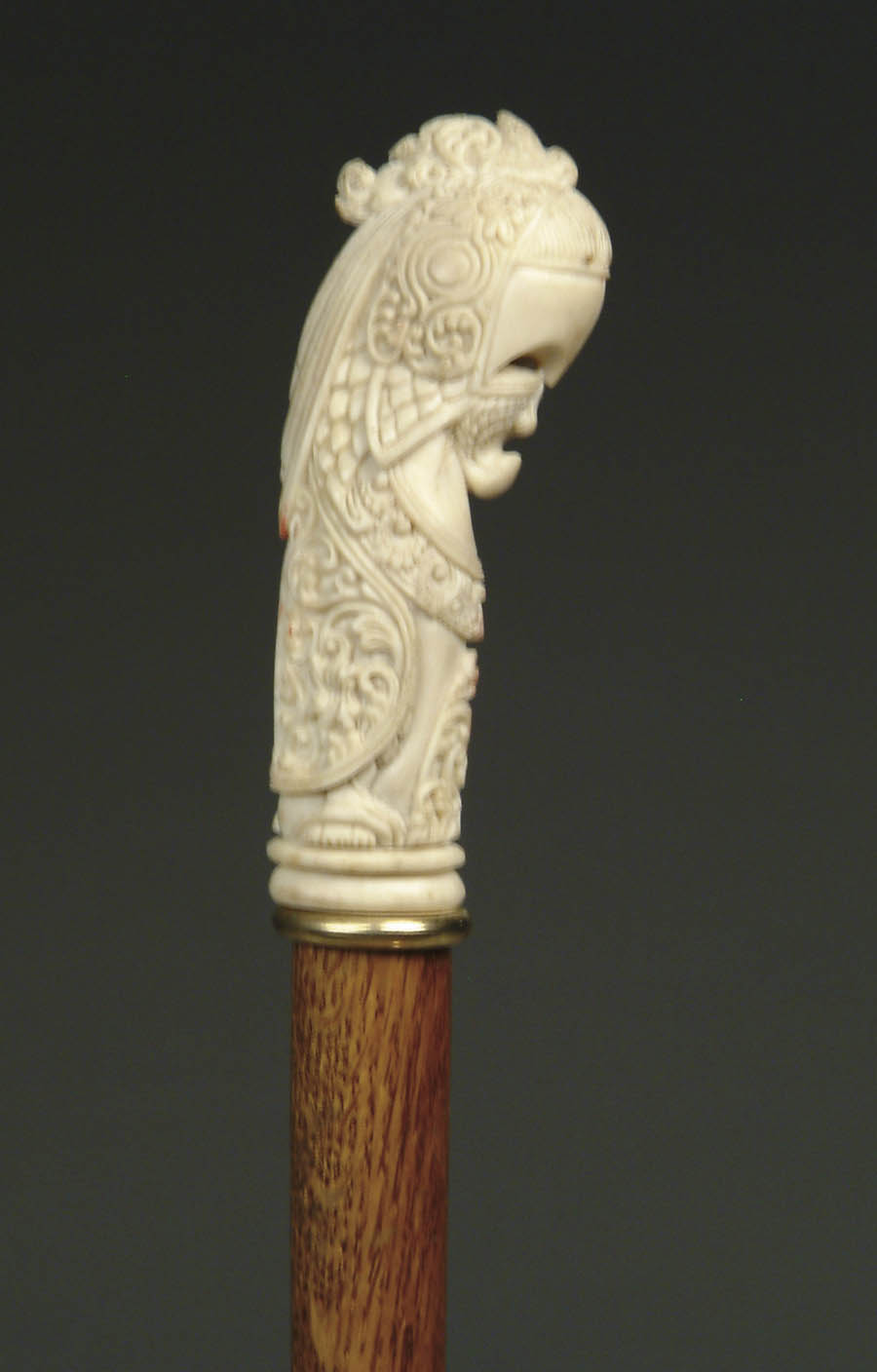 Appraisal: CARVED IVORY PARROT CANE Tall handle has a stylized parrot