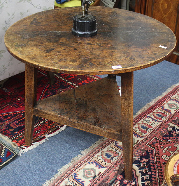 Appraisal: A TH CENTURY CIRCULAR OAK CRICKET TABLE the three legs