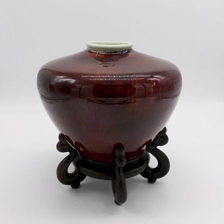 Appraisal: FLAMBE GLAZE VASE WITH STAND The body of tapering form